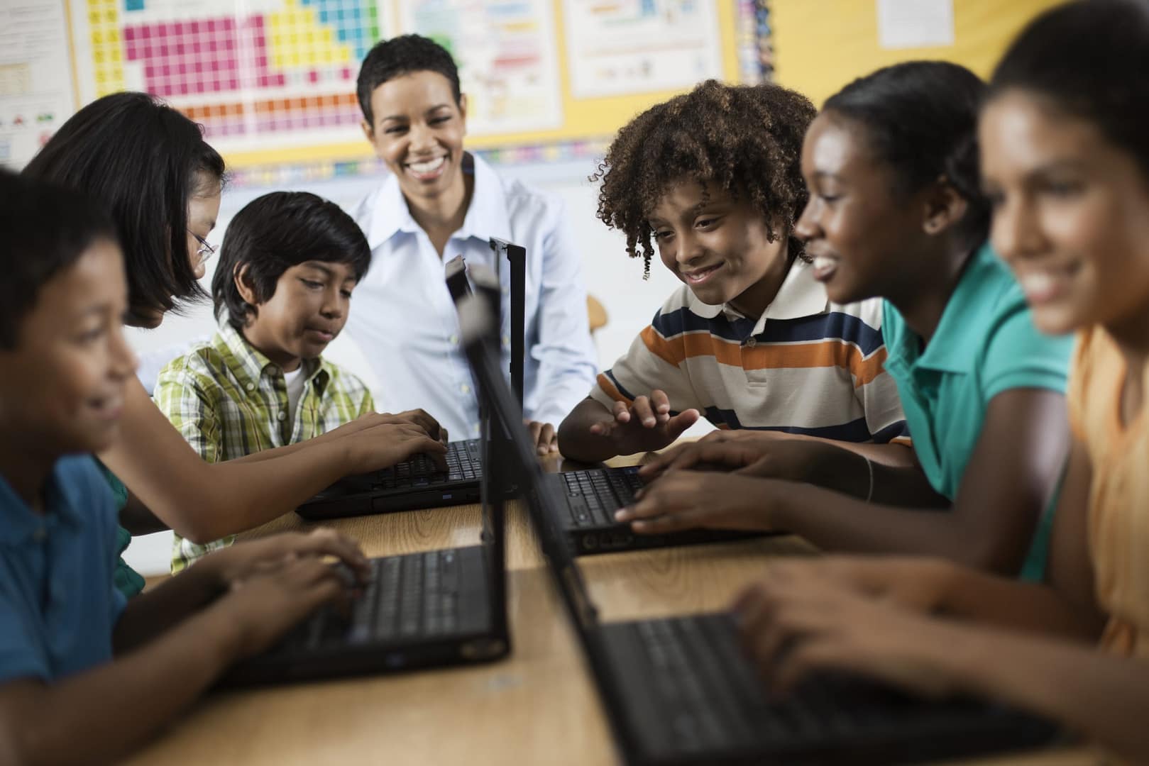 school,usa,a group of students using laptops in a lesson.